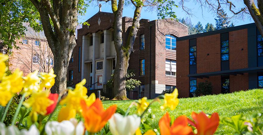Beautiful flowers bloom in front of Seattle Pacific University's McKinley Hall.